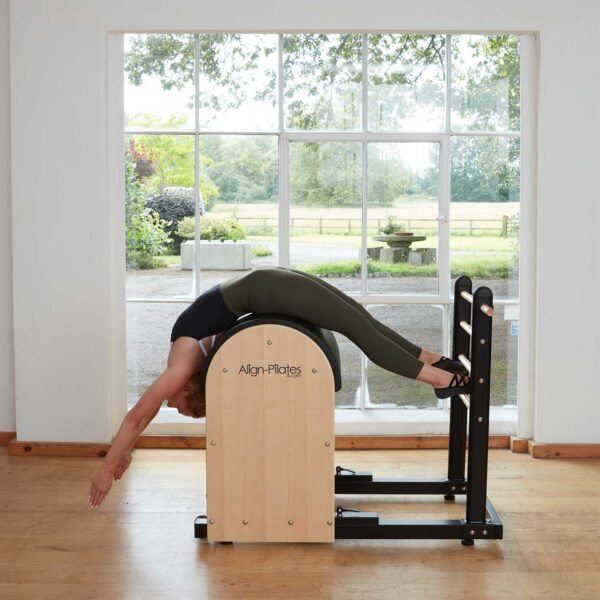 Pilates instructor performing a ladder barrel exercise