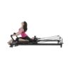 Working out on H1 home Pilates reformer